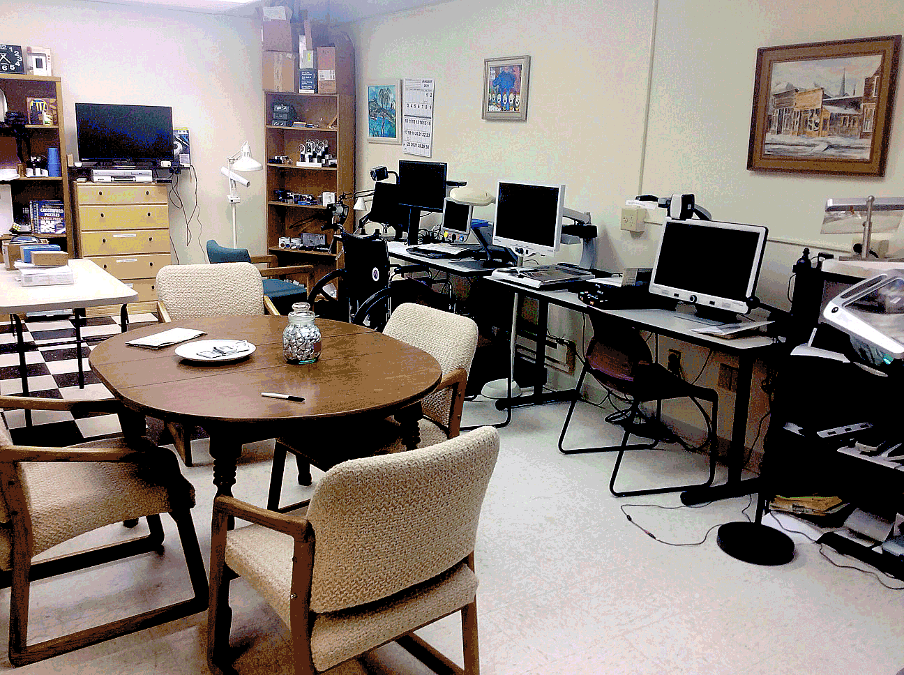 2 images of the Bozeman Vision Center, with a kitchen area, some tables and along the wall are computers, optical character reading devices and magnifiers