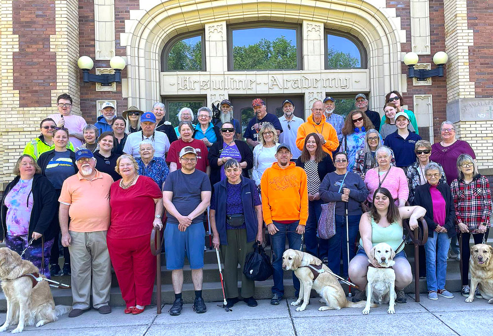 The Summer Orientation Building and a group of Graduates and staff from 2024
